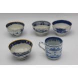 Four Chinese, Qing, 18th century blue and white tea bowls and a cup, each decorated with a river