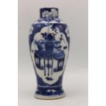 A Chinese, 19th century blue and white vase, decorated to the back and front with panels of a table,