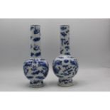 A near pair of Chinese Qing dynasty blue and white bottle vases, late 19th century each, decorated
