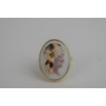 An oval cameo ring in a 9ct gold setting, depicting a 1920's female wearing a head scarf, total