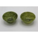 A pair of 20th century Chinese green jade coloured tea bowls, 4.5cm high, 7.5cm dia
