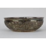 An Indian, late 19th century silver bowl of oval shape, embossed and chased with a continuous