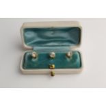 A set of three 9ct gold dress studs each set with a paste stone, 2.6g in a fitted case
