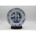A Chinese Kangxi blue and white plate decorated to the centre with two ladies each holding a sprig
