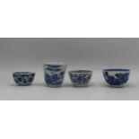 Four Qing, 18th century Chinese, blue and white tea bowls, two decorated with a garden scene, one