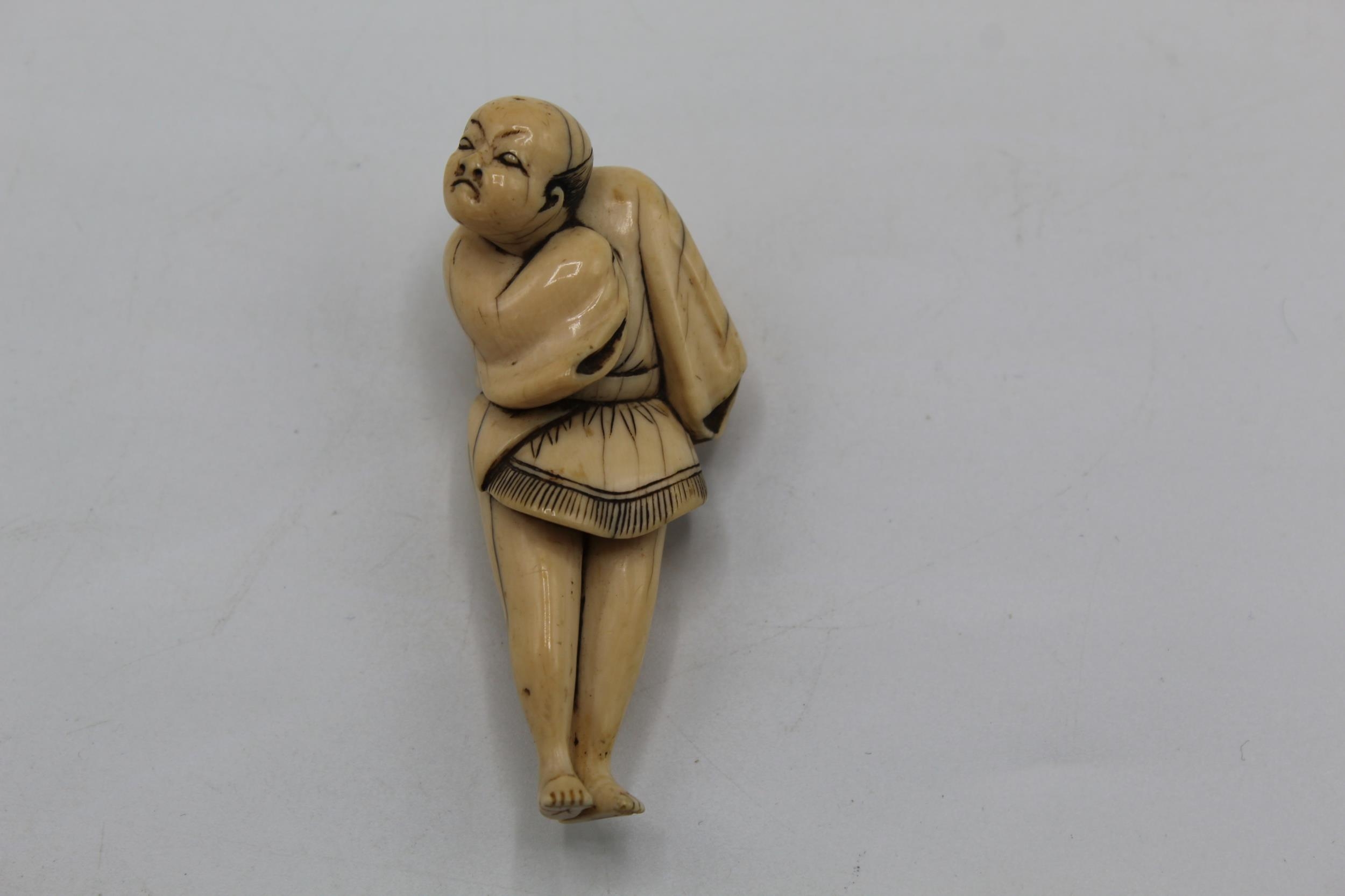 An 18th century Japanese ivory netsuke of a standing Yakkosan, 6.3cm high