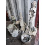 A selection of garden composition ornaments to include one of a faun playing with a flute Location: