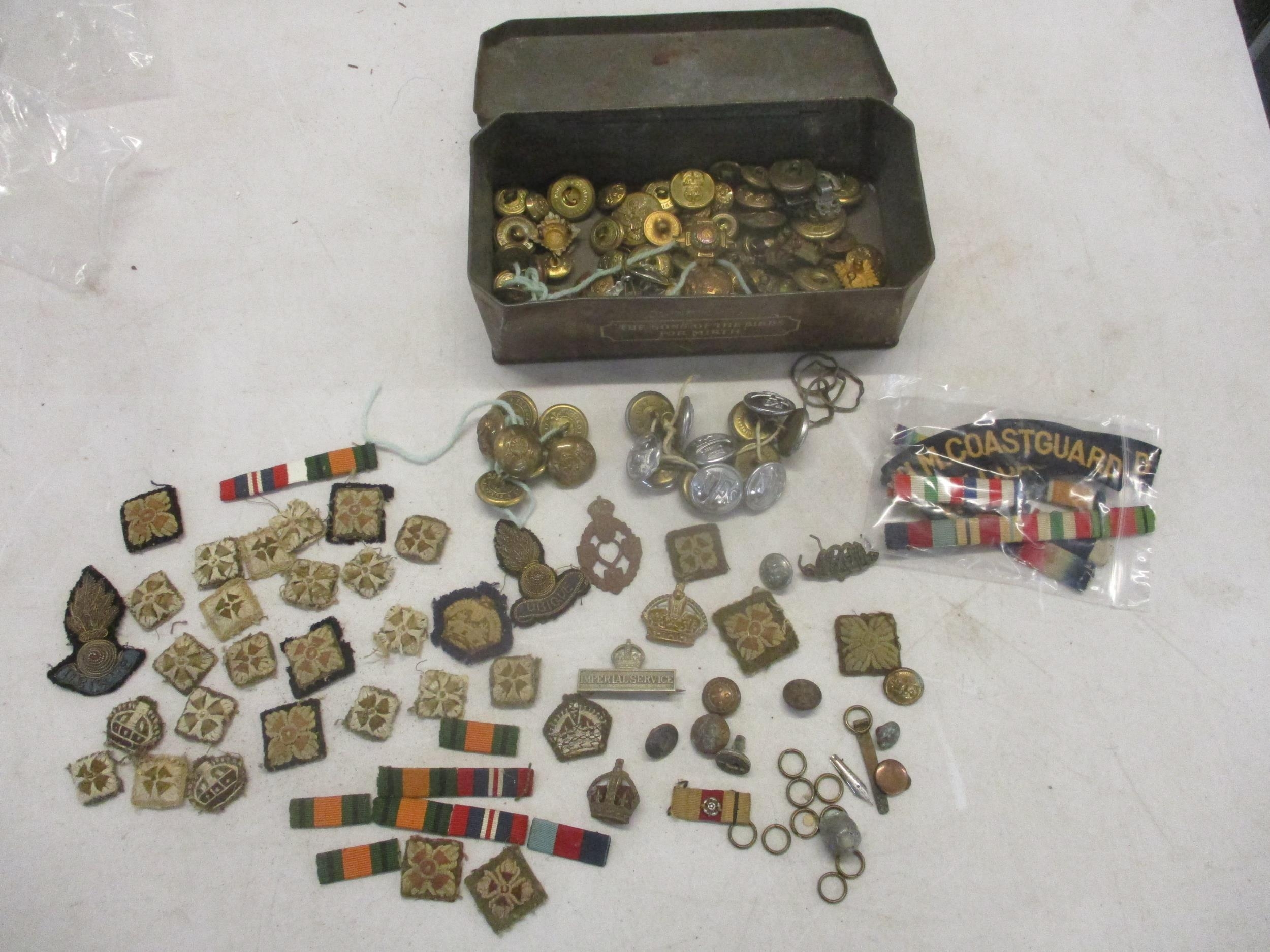 A quantity of military, fire service and coastguard buttons, cloth badges and ribbon bars and