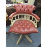 A reproduction leather button back upholstered swivel Captains office armchair Location: