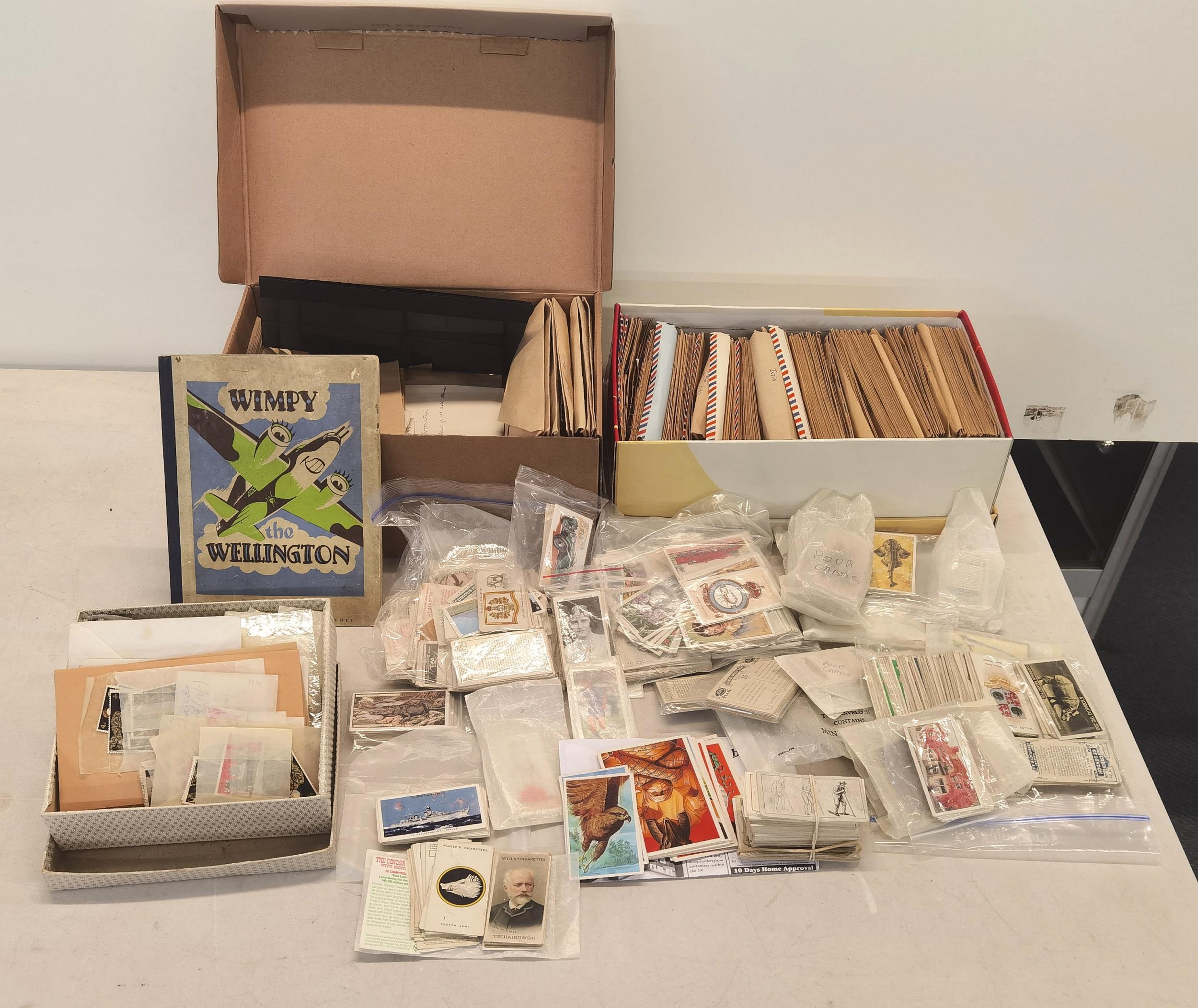 A selection of loose stamps, together with cigarette cards