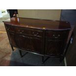 An early 20th century mahogany sideboard having a gadrooned edge with drawers and cupboards below,