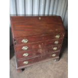 A Georgian mahogany bureau having a fall flap revealing a fitted interior above four graduating