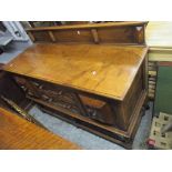An early 20th century oak sideboard having a raised back and two drawers flanked by cupboard