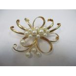 A yellow metal brooch with fourteen pearls, tests as gold, 18.8g Location: