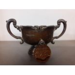 A silver twin handled trophy cup together with a silver swimming medal, 82.2g Location: