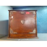 An early 20th century oak writing/stationary box with metal brackets, shield decoration, a key and