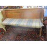 A light oak two seater bench with loose cushion seat, 84cm x 136cm x 42cm Location: RAF