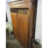 A 19th century walnut Armoire having a stepped cornice with two panelled doors on metal supports,