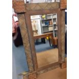 An Indonesian inspired wall mirror by Austin, metallic and rattan effect, 73cm x 122cm, a Country