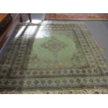 A late 20th century Moroccan green ground hand woven rug with central quatrefoil medallion,