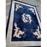 A black ground modern Chinese rug with images of dragons, 275cm x 182cm Location: SL