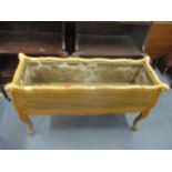 An early 20th century planter with cane woven sides, brass liner on French cabriole legs 61cm x