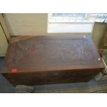 An early 20th century Oriental carved camphor wood blanket box with internal candle box, inset