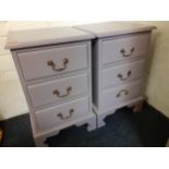 A pair of lilac painted pine bedside cabinets of three drawers, each on a plinth base Location: BWR