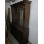 A reproduction mahogany side display cabinet with carved decoration, three arched glass doors with