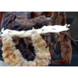 A quantity of fur collars, trims and stoles together with a mid 20th century mink coat, tassels