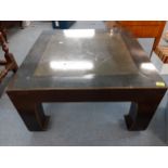 An oriental style black lacquered, square formed coffee table with inset composition top in the