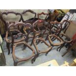 A matched set of eight Victorian rosewood dining chairs having scroll decoration and on cabriole