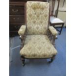 A Victorian walnut open armchair with upholstered seat and back and armrests with baluster supports,