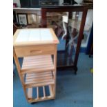 A small mahogany display cabinet deficient of shelves together with a modern square formed tiered