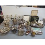 A large mixed lot of silver plate to include candelabras, entrée dish, serving ladle, teapots,
