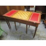 A reproduction games table with two slide out tables on reeded legs, 51.5h x 81cm w Location: