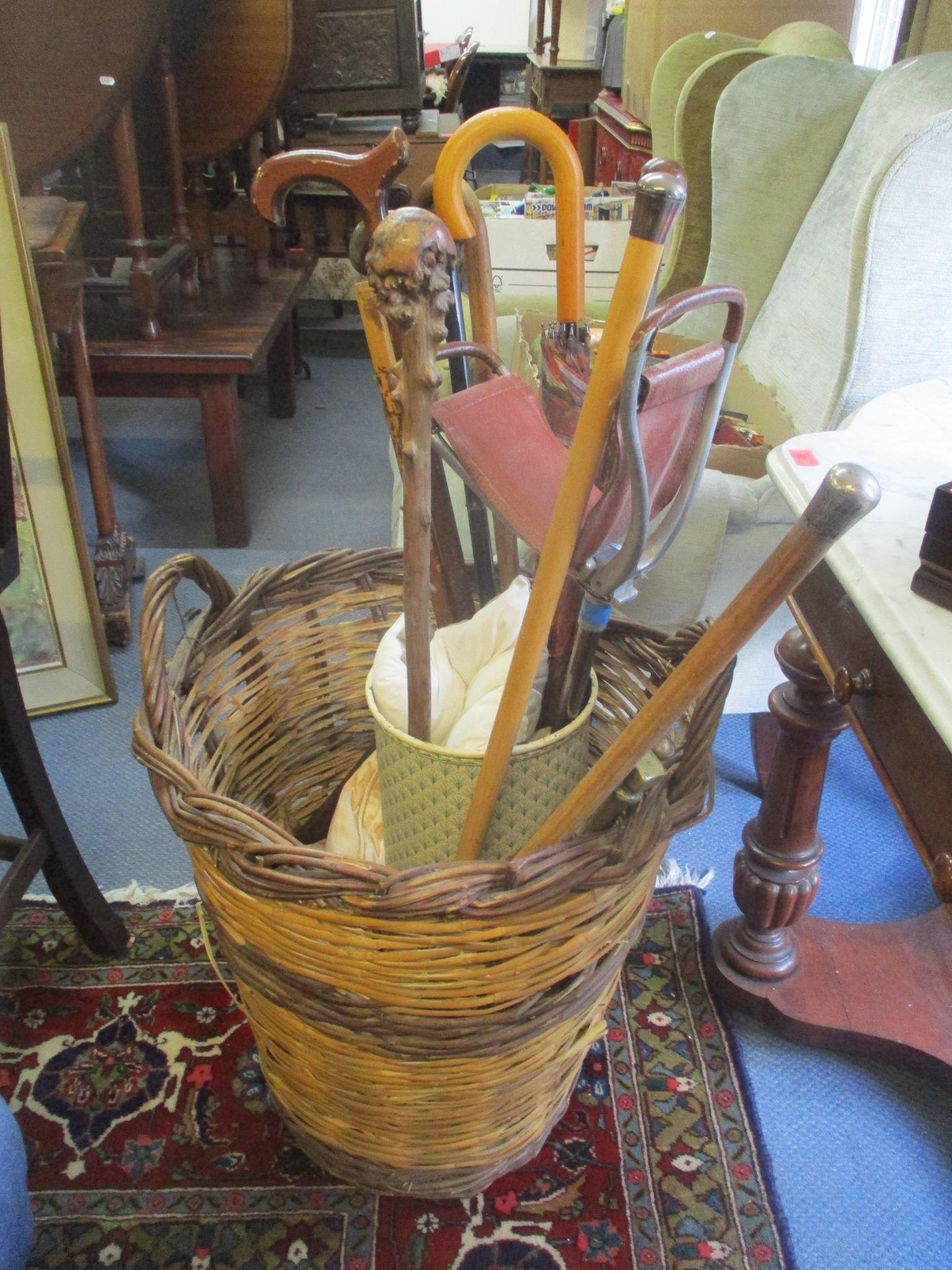Mixed walking sticks, together with a shooting stick, fire implements and a wicker basket