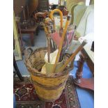 Mixed walking sticks, together with a shooting stick, fire implements and a wicker basket