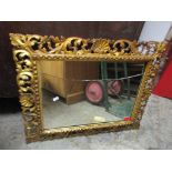 A late 19th century Continental gilt wood carved picture frame with inset mirror A/F, 68cm x 55cm