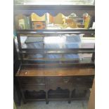 A 19th century oak dresser having a plate rack with faux drawers above five short drawers with