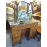 A George III mahogany kneehole desk having one long drawer with fitted compartments, cupboard door