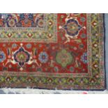 An Iranian hand woven carpet, large central floral and geometric design on a blue ground, multi