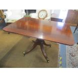 An early 19th century mahogany breakfast table having a turned support and on four splayed legs 73cm