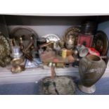 A vintage lot to include bicycle lamps, pewter and silver plate, brass candlesticks, a wall clock, a