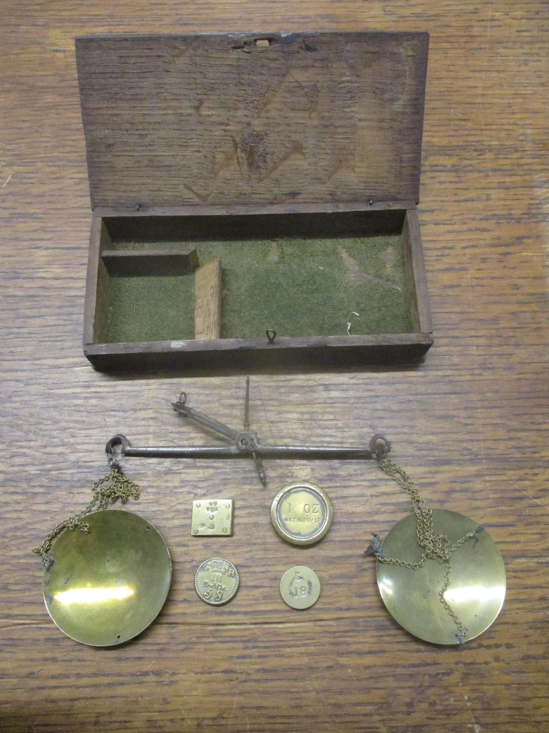 A wooden cased brass goldsmiths scales with various weights to include a George III 5:8 guinea