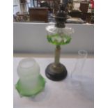 A Victorian gilt brass column oil lamp with clear glass reservoir having applied green trailing, one