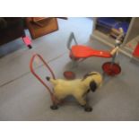 A vintage Pedigree soft toys donkey pull along toy, and a vintage tin plate child's tricycle with