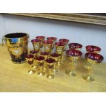 Venetian red, floral enamelled and gilt glass comprising of a wine cooler, a set of six wines