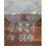 Two large glass succulent plant containers in the carboy style together with glass sundae dishes and