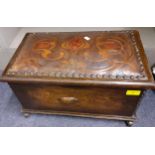 An Art Nouveau oak chest on castors having a leather top with organic design, 25cm h x 47cm w x 28cm